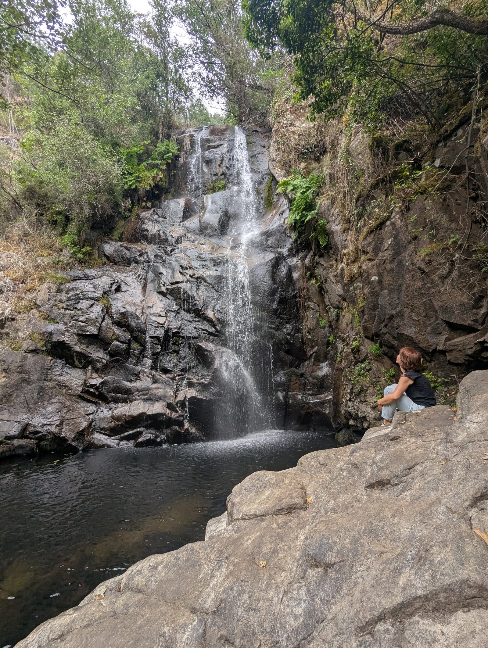 Contemplating by a waterfall